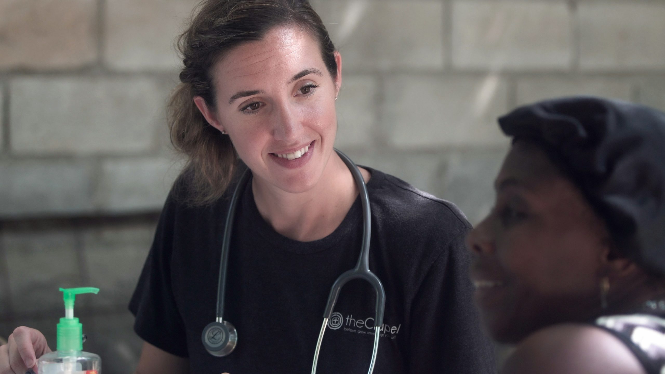White female health care professional with Black female patient